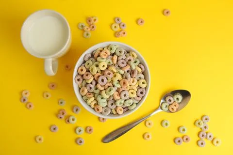 Multicolored corn rings for breakfast on a colored background Stock Photos