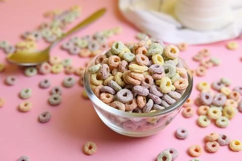 Multicolored corn rings for breakfast on a colored background Stock Photos