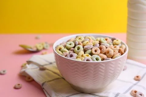 Multicolored corn rings for breakfast on a colored background Stock Photos