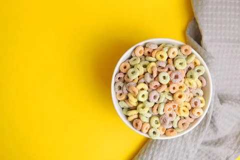 Multicolored corn rings for breakfast on a colored background Stock Photos