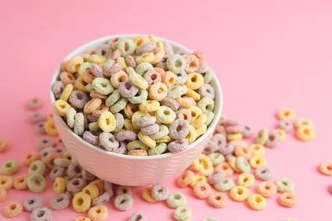 Multicolored corn rings for breakfast on a colored background Foto stock