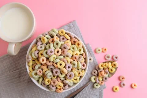 Multicolored corn rings for breakfast on a colored background Foto stock