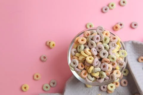 Multicolored corn rings for breakfast on a colored background Stock Photos