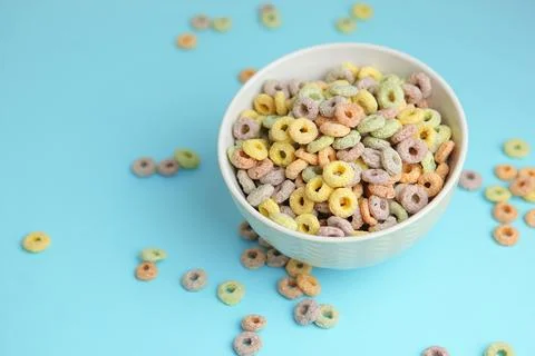 Multicolored corn rings for breakfast on a colored background Stock Photos