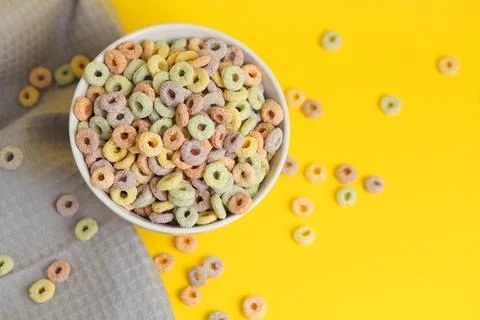 Multicolored corn rings for breakfast on a colored background Stock Photos