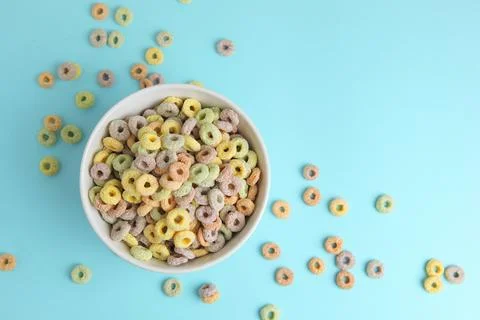 Multicolored corn rings for breakfast on a colored background Stock Photos