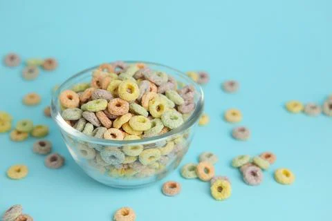 Multicolored corn rings for breakfast on a colored background Foto stock
