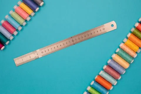 Multicolored cotton threads, spools, cutter line, handmade sewing. Top view with Stock Photos