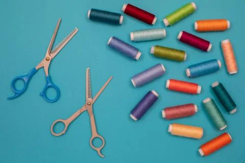 Multicolored cotton threads, spools, scissors, handmade sewing. Top view with Stock Photos