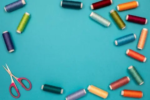 Multicolored cotton threads, spools, scissors, handmade sewing. Top view with Stock Photos