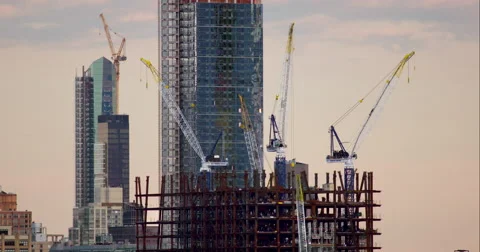Multicolored cranes standing still on New York City construction site Stock Footage 67296600