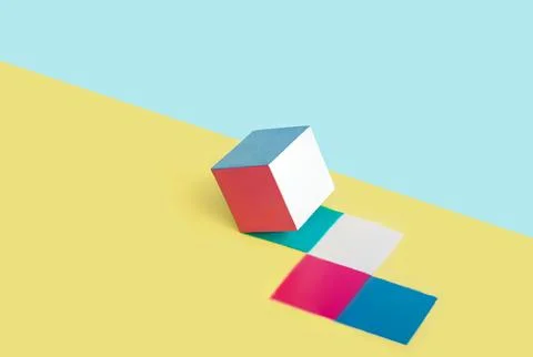 Multicolored cube leaves marks on a yellow and blue background Stock Photos