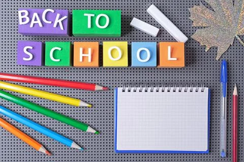 Multicolored cubes with the inscription "Back to school" and school supplies. Stock Photos