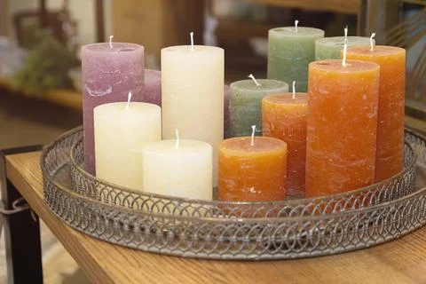 Multicolored decorative candles on the table Stock Photos