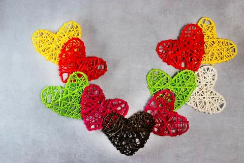 Multicolored decorative hearts on a gray background. Valentine's Day Concept. Stock Photos