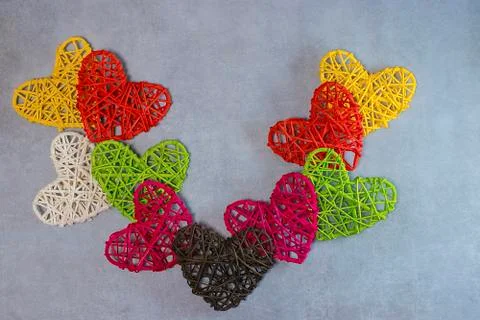 Multicolored decorative hearts on a gray background. Valentine's Day Concept. Stock Photos