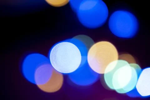 Multicolored defocused light. Christmas twinkling lights background Stock Photos