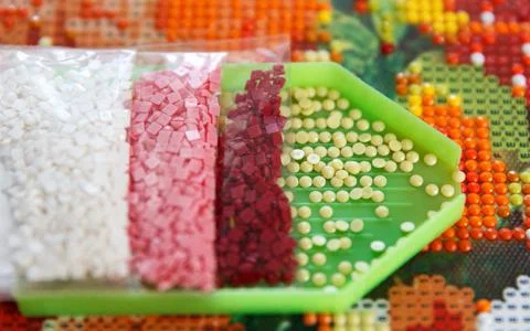 Multicolored diamond strases in container for handmade process of creation of Stock Photos