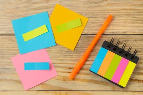 Multicolored different notes post-it on wooden office table background .mocku Stock Photos