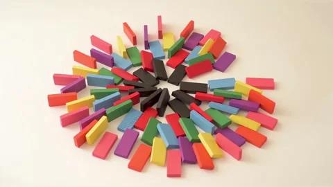 Multicolored dominos forming a circle falling in chain reaction Stock Footage 303589405