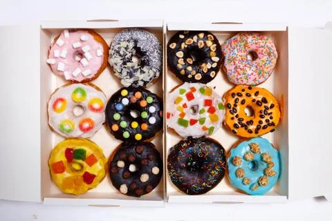 Multicolored donuts isolated on white background. Top view Stock Photos