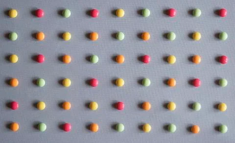 Multicolored dragees arranged in rows Stock Photos