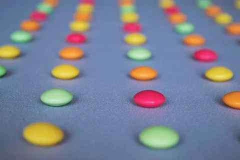 Multicolored dragees arranged in rows Stock Photos