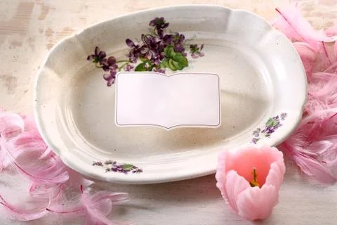 Multicolored Easter decoration with plate and flowers Stock Photos