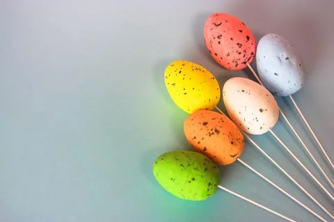 Multicolored Easter decorative eggs on a gently blue background. Space for te Stock Photos