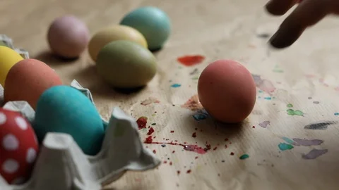 Multicolored Easter eggs lie on colored kraft paper Video stock 125437736