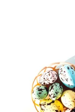 Multicolored Easter eggs lie in a round basket. the view from the top. The Stock Photos