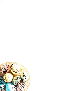 Multicolored Easter eggs lie in a round basket. the view from the top. The Stock Photos