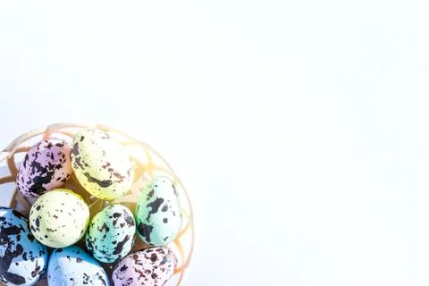 Multicolored Easter eggs lie in a round basket. the view from the top. The Stock Photos