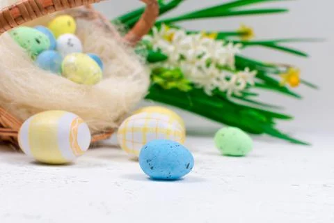 Multicolored Easter eggs in pastel colors on a white table against the Stock Photos