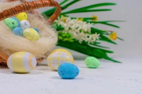Multicolored Easter eggs in pastel colors on a white table against the Stock Photos
