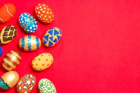 Multicolored Easter eggs on a red background banner. Stock Photos
