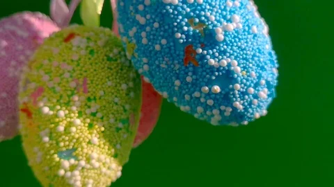 Multicolored Easter eggs rotate on a green background Stock Footage 105926154