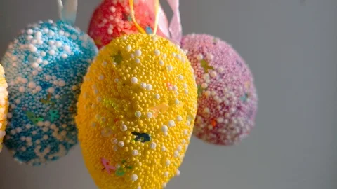 Multicolored Easter eggs swing on a light background Stock Footage 105926155