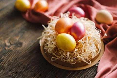 Multicolored Easter eggs on a wooden background. Stock Photos