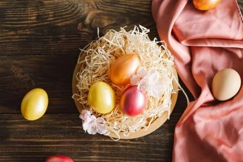 Multicolored Easter eggs on a wooden background. Stock Photos