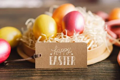 Multicolored Easter eggs on a wooden background. Stock Photos
