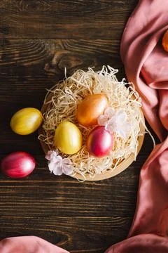 Multicolored Easter eggs on a wooden background. Stock Photos