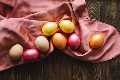 Multicolored Easter eggs on a wooden background. Stock Photos