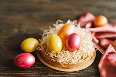 Multicolored Easter eggs on a wooden background. Stock Photos