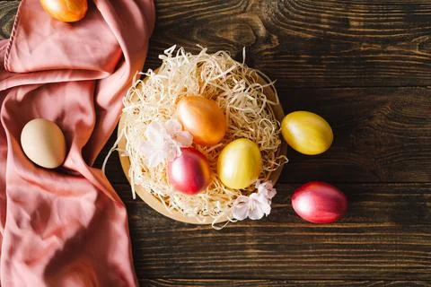 Multicolored Easter eggs on a wooden background. Stock Photos