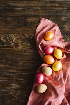 Multicolored Easter eggs on a wooden background. Stock Photos