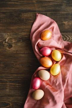 Multicolored Easter eggs on a wooden background. Stock Photos