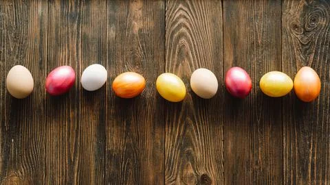 Multicolored Easter eggs on a wooden background. Stock Photos