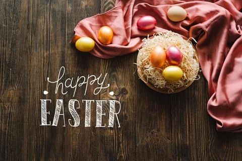 Multicolored Easter eggs on a wooden background. Stock Photos