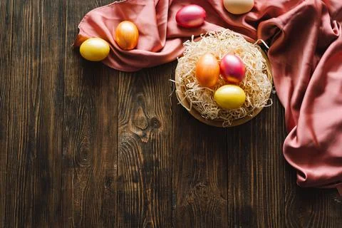 Multicolored Easter eggs on a wooden background. Stock Photos
